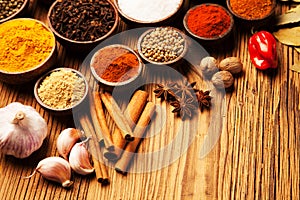 Spices and herbs in wooden bowls.