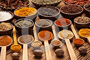 Spices and herbs in wooden bowls.