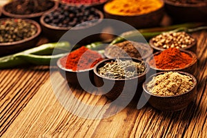 Spices and herbs in wooden bowls.