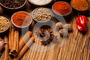 Spices and herbs in wooden bowls.