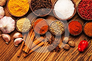 Spices and herbs in wooden bowls.