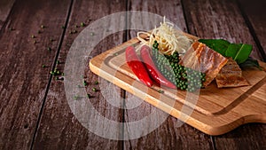 Spices with ingredients  Stir-Fried Spicy and herb with dried fish fillet on a cutting board with wooden dark background. Thai