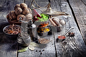 Spices and nuts at wooden table