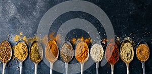 Spices in spoons background. Varieties of spices turmeric, pepper, chili, coriander, cinnamon and peppers for cooking. Culinary
