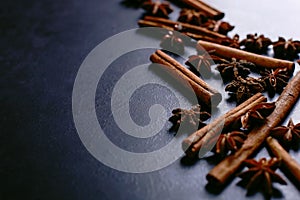 Spices sticks cinnamon and star anise on the old table. Rustic dark background, aroma close-up, macro