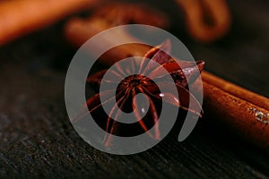 Spices sticks cinnamon and star anise on the old table. Rustic dark background, aroma close-up, macro