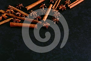 Spices sticks cinnamon and star anise on the old table. Rustic dark background, aroma close-up, macro