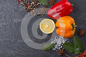 Spices on the stone black background. Condiments on a dark table