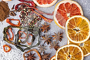 Spices on the stone black background. Condiments on a dark table