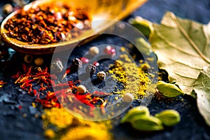 Spices. Various Indian spices on black stone table. Spice and herbs on slate background