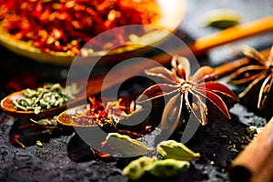 Spices. Various Indian spices on black stone table. Spice and herbs on slate background