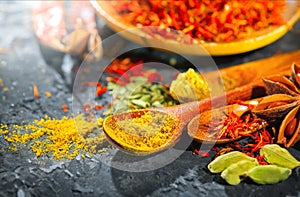 Spices. Various Indian Spices on black stone table. Spice and herbs on slate background. Assortment of Seasonings, condiments