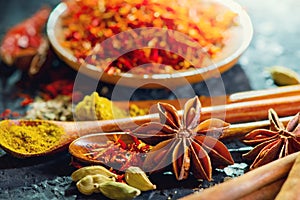 Spices. Various Indian Spices on black stone table. Spice and herbs on slate background. Assortment of Seasonings, condiments