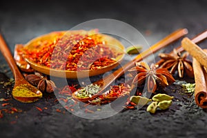 Spices. Various Indian Spices on black stone table. Spice and herbs on slate background. Assortment of Seasonings, condiments