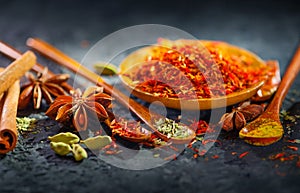 Spices. Various Indian Spices on black stone table. Spice and herbs on slate background. Assortment of Seasonings, condiments