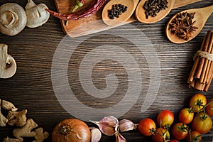 Spices and vegetables in anticipation of cooking on a wooden table