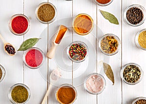 Spices on white wooden background. Food flavor enhancers