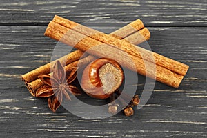Spices on wooden background. Cinnamon, nuts, anise and cloves. Christmas background