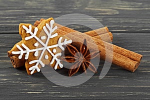 Spices on wooden background. Cinnamon sticks, anise and gingerbread