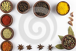 Spices in a wooden bowl isolated on a white background