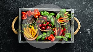 Spices in a wooden box: basil, pepper, oil, paprika, herbs. Food background.