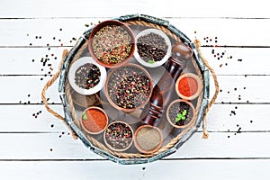 Spices in a wooden box. Colored pepper, sea salt, ground pepper, chili pepper.