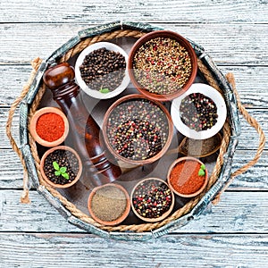 Spices in a wooden box. Colored pepper, sea salt, ground pepper, chili pepper.