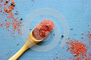 Spices in a wooden spoon. Various Indian spices on black stone table