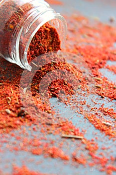 Spices in a wooden spoon. Various Indian spices on black stone table