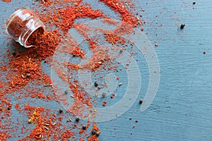 Spices in a wooden spoon. Various Indian spices on black stone table