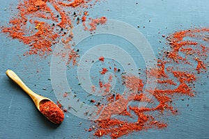 Spices in a wooden spoon. Various Indian spices on black stone table