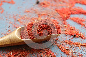 Spices in a wooden spoon. Various Indian spices on black stone table