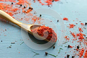 Spices in a wooden spoon. Various Indian spices on black stone table