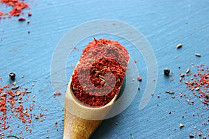 Spices in a wooden spoon. Various Indian spices on black stone table