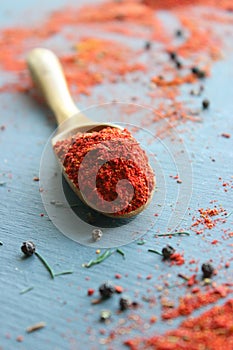 Spices in a wooden spoon. Various Indian spices on black stone table