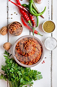 Spicy adjika from pepper, nuts and herbs. Top view.