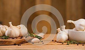 Spicy background of garlic and spices, rosemary, black pepper, and thyme. Concept of cooking, recipe book and home cooking