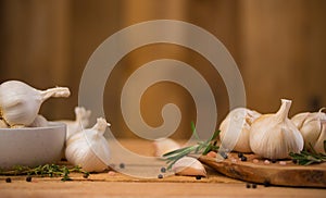 Spicy background of garlic and spices, rosemary, black pepper, and thyme. Concept of cooking, recipe book and home cooking