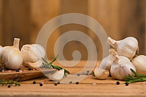 Spicy background of garlic and spices, rosemary, black pepper, and thyme. Concept of cooking, recipe book and home cooking