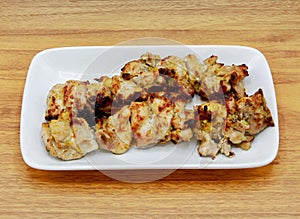 Spicy bbq chicken malai tikka boti kabab served in a dish isolated on grey background side view of indian, pakistani food
