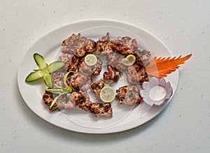 Spicy bbq chicken malai tikka boti served in a dish isolated on grey background top view of indian, pakistani food