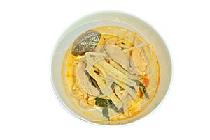 Spicy boiled slice fresh bamboo shoot with chicken and blood in coconut milk curry soup on bowl