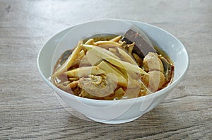 spicy boiled slice fresh bamboo shoot with chicken and blood in coconut milk curry soup in bowl