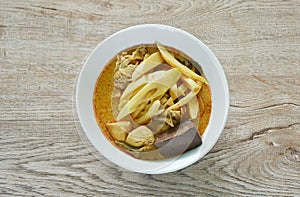 spicy boiled slice fresh bamboo shoot with chicken and blood in coconut milk curry soup in bowl