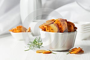 Spicy bruschetta crackers with rosemary on a white kitchen table