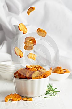 Spicy bruschetta crackers with rosemary on a white kitchen table