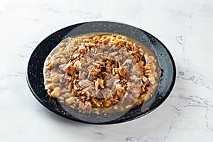 Spicy Chana chat masala chotpoti in a black dish isolated on background top view of indian, bangali and pakistani food chat pata