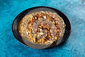 Spicy Chana chat masala chotpoti in a black dish isolated on background top view of indian, bangali and pakistani food chat pata