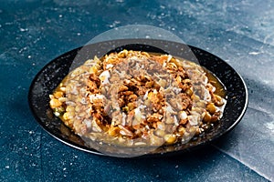 Spicy Chana chat masala chotpoti in a black dish isolated on background top view of indian, bangali and pakistani food chat pata