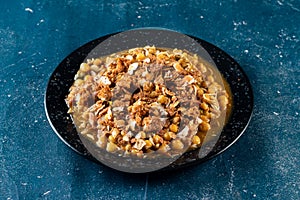 Spicy Chana chat masala chotpoti in a black dish isolated on background top view of indian, bangali and pakistani food chat pata